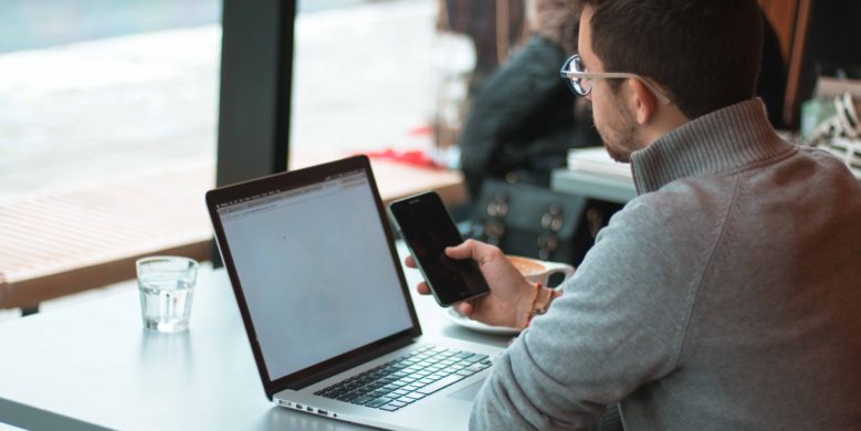 A rate-sensitive loan borrower in front of notebook